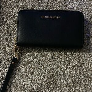 black Michael kors wallet wristlet with gold hardware. new w/ original packaging